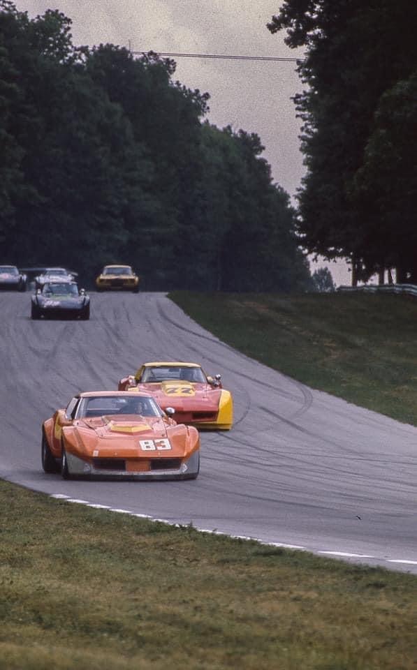 Orange No. 83 Corvette leading pack